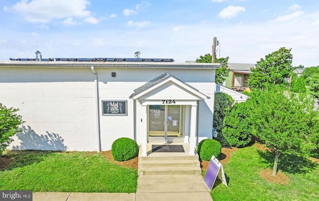  - view of front of property featuring concrete block siding