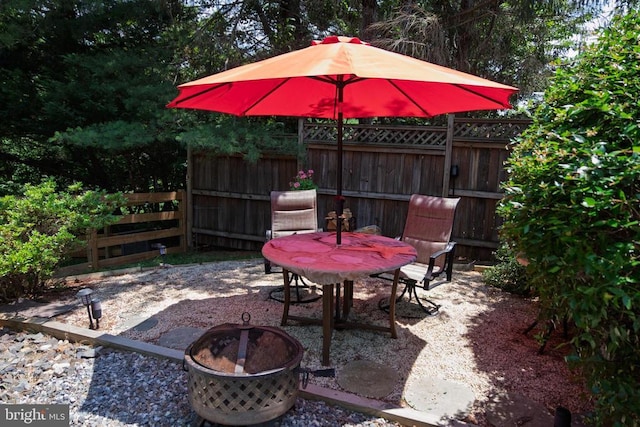  - view of patio / terrace featuring a fire pit and outdoor dining space