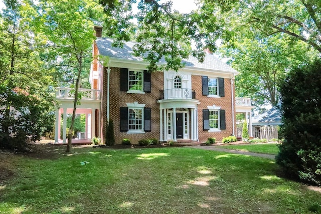 645 Cherry Ave, Waynesboro, VA 22980 - colonial house featuring a balcony, a front lawn, a chimney, and brick siding