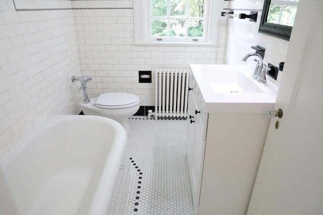 645 Cherry Ave, Waynesboro, VA 22980 - bathroom with radiator, a bath, vanity, tile walls, and toilet