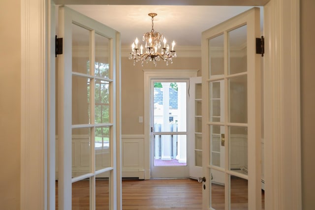 645 Cherry Ave, Waynesboro, VA 22980 - entryway featuring wood finished floors, a chandelier, a decorative wall, wainscoting, and french doors