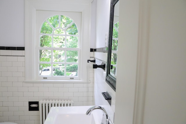 645 Cherry Ave, Waynesboro, VA 22980 - bathroom featuring radiator, tile walls, and a sink