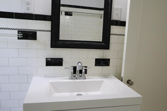 645 Cherry Ave, Waynesboro, VA 22980 - bathroom with vanity, decorative backsplash, and tile walls