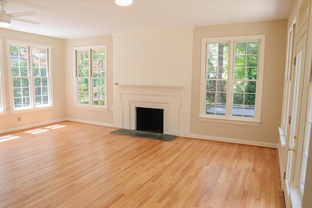 645 Cherry Ave, Waynesboro, VA 22980 - unfurnished living room featuring light wood-style flooring, baseboards, a ceiling fan, and a fireplace