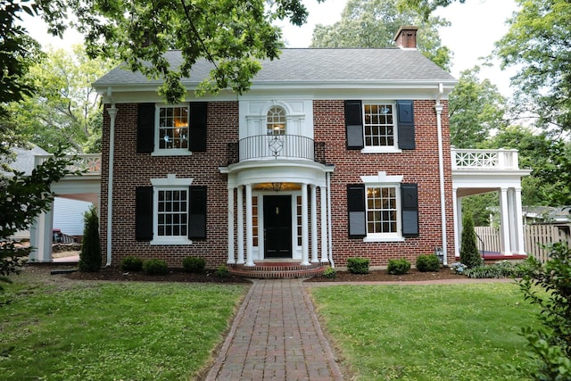 645 Cherry Ave, Waynesboro, VA 22980 - colonial house featuring a balcony, a front yard, and brick siding