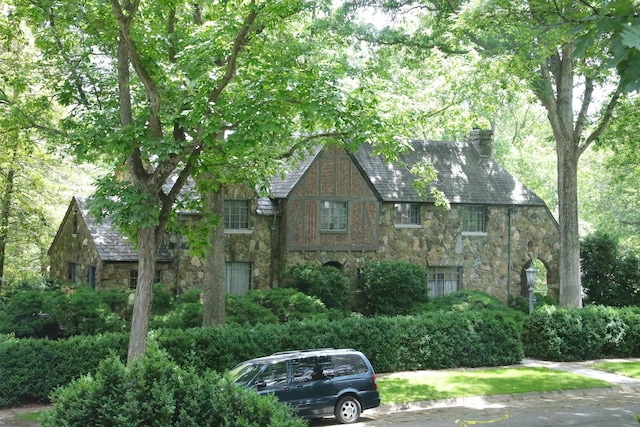 645 Cherry Ave, Waynesboro, VA 22980 - tudor-style house featuring stone siding, a chimney, and a high end roof