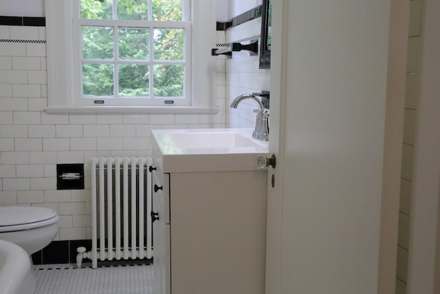 645 Cherry Ave, Waynesboro, VA 22980 - bathroom featuring radiator heating unit, tile walls, vanity, tile patterned flooring, and toilet