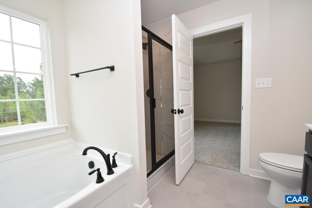 bathroom featuring a stall shower, toilet, and a bath