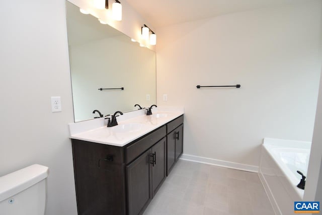 219 Riva Way, Palmyra, VA 22963 - bathroom featuring toilet, baseboards, double vanity, a tub to relax in, and tile patterned floors