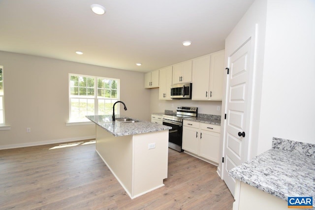 219 Riva Way, Palmyra, VA 22963 - kitchen with stainless steel appliances, a sink, white cabinets, light wood-type flooring, and recessed lighting