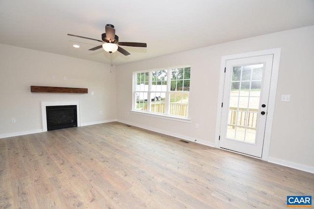 219 Riva Way, Palmyra, VA 22963 - unfurnished living room with wood finished floors, ceiling fan, a fireplace, and baseboards