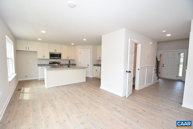 219 Riva Way, Palmyra, VA 22963 - kitchen with appliances with stainless steel finishes, a sink, white cabinets, light wood finished floors, and recessed lighting