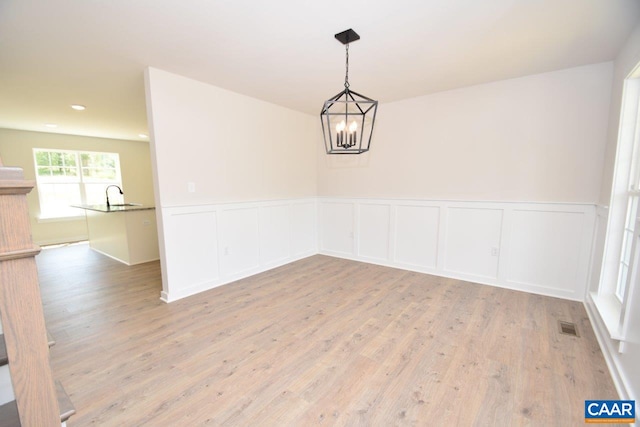 219 Riva Way, Palmyra, VA 22963 - unfurnished dining area featuring light wood-style flooring, a chandelier, a wainscoted wall, a decorative wall, and recessed lighting
