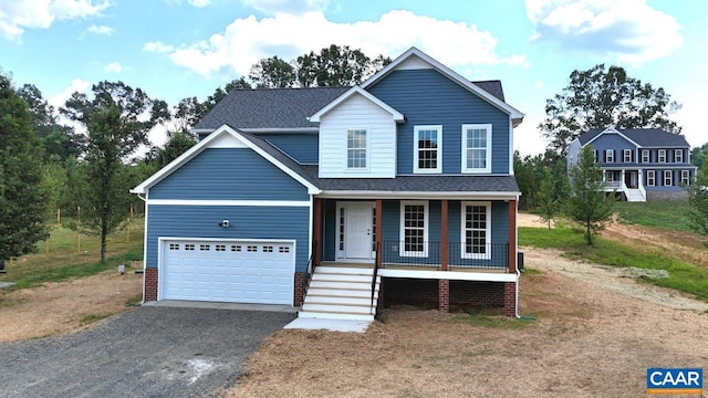 view of front of house featuring covered porch, aphalt driveway, an attached garage, and a shingled roof