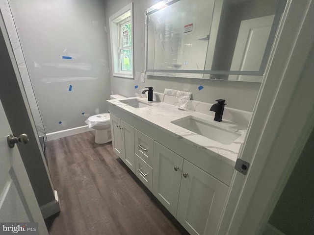  - full bathroom with wood finished floors, double vanity, and a shower