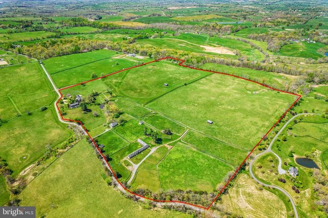 birds eye view of property with a rural view