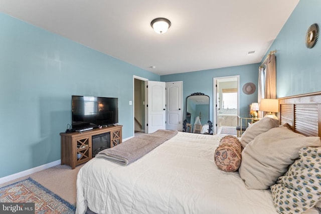 bedroom featuring baseboards, carpet floors, and connected bathroom
