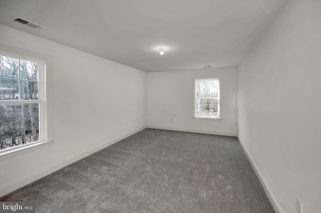  - spare room featuring carpet floors and baseboards