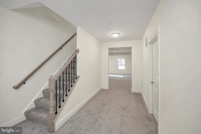  - hall with carpet floors, baseboards, and stairs