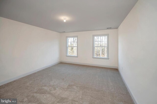  - spare room featuring baseboards and carpet