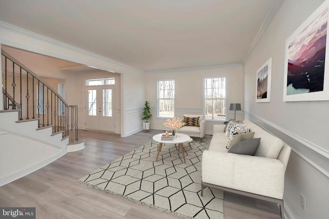 - living room featuring stairway, ornamental molding, wood finished floors, and baseboards