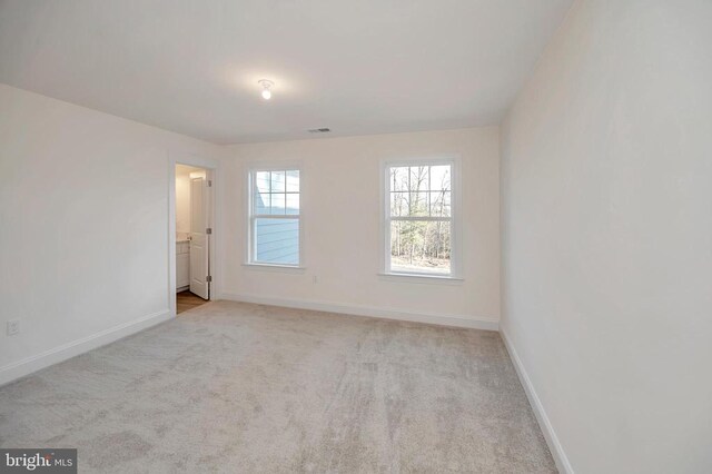  - empty room featuring baseboards and light colored carpet