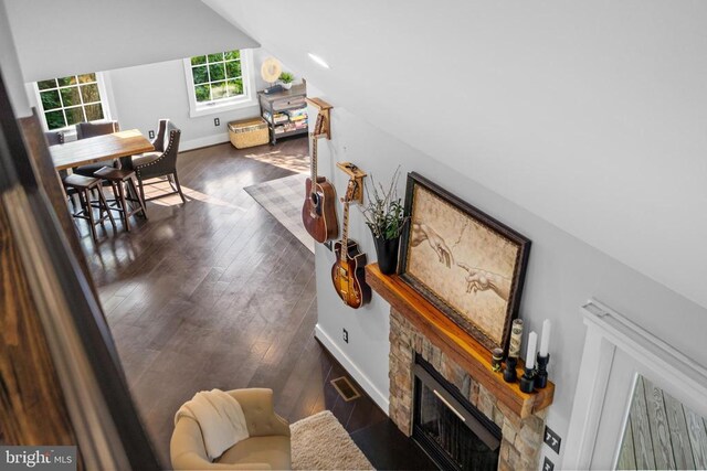 93 Tyro Ln, Roseland, VA 22967 - living area featuring lofted ceiling, a stone fireplace, dark wood-style floors, and baseboards