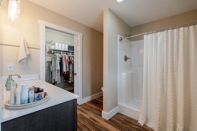 375 Mesa Ct, Broadway, VA 22815 - full bathroom featuring wood finished floors, vanity, curtained shower, and a walk in closet
