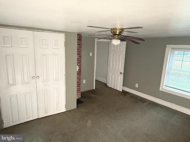  - unfurnished bedroom featuring dark colored carpet and a ceiling fan
