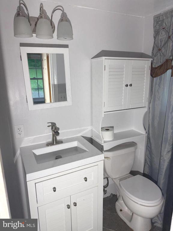  - full bath with vanity and curtained shower
