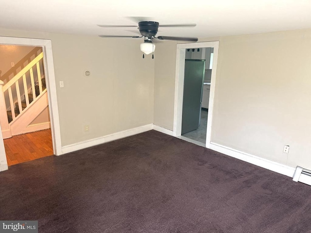  - empty room featuring stairs, ceiling fan, and dark carpet