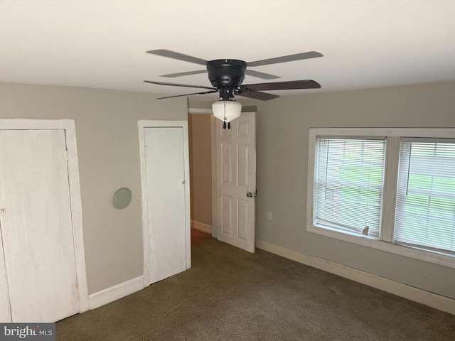  - unfurnished bedroom featuring carpet flooring, multiple windows, and ceiling fan
