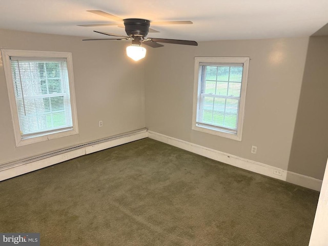  - unfurnished room featuring a baseboard heating unit, dark carpet, and ceiling fan