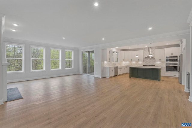 10A Sablewood Dr, Charlottesville, VA 22911 - unfurnished living room featuring crown molding, light wood-style flooring, recessed lighting, and baseboards