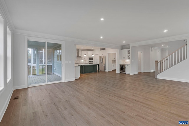 10A Sablewood Dr, Charlottesville, VA 22911 - unfurnished living room featuring crown molding, light wood finished floors, baseboards, stairway, and recessed lighting