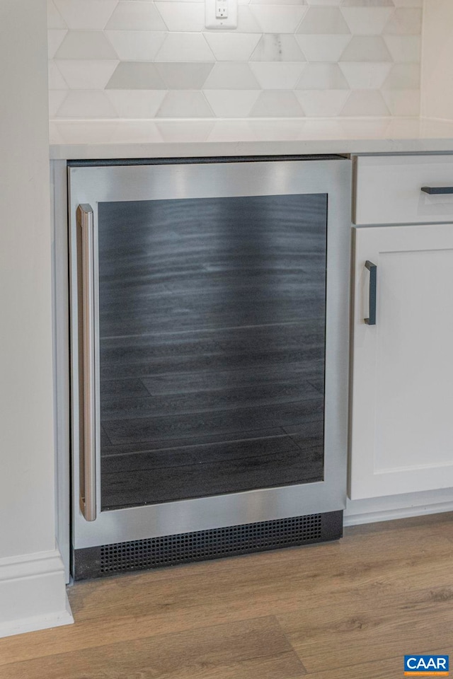10A Sablewood Dr, Charlottesville, VA 22911 - detailed view of wine cooler, white cabinetry, wood finished floors, and light countertops