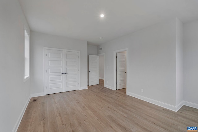 10A Sablewood Dr, Charlottesville, VA 22911 - unfurnished bedroom featuring light wood-type flooring, baseboards, a closet, recessed lighting, and multiple windows