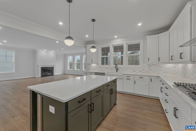 10A Sablewood Dr, Charlottesville, VA 22911 - kitchen featuring a sink, decorative backsplash, light wood-style floors, ornamental molding, and recessed lighting