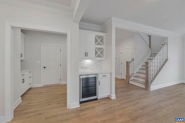 10A Sablewood Dr, Charlottesville, VA 22911 - indoor dry bar featuring beverage cooler, ornamental molding, stairs, light wood-style floors, and backsplash