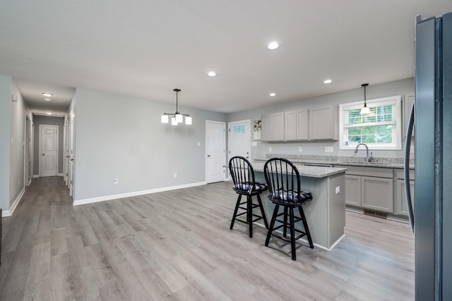 4001 Moreland Gap Rd, New Market, VA 22844 - kitchen with freestanding refrigerator, a sink, a kitchen breakfast bar, light wood-style flooring, and recessed lighting