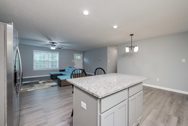 4001 Moreland Gap Rd, New Market, VA 22844 - kitchen featuring stainless steel fridge, a center island, light wood-style flooring, a ceiling fan, and open floor plan