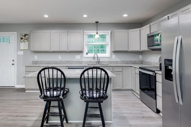 4001 Moreland Gap Rd, New Market, VA 22844 - kitchen featuring appliances with stainless steel finishes, a sink, recessed lighting, a breakfast bar, and light wood-style floors