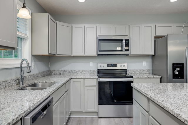 4001 Moreland Gap Rd, New Market, VA 22844 - kitchen featuring appliances with stainless steel finishes, a sink, recessed lighting, light wood finished floors, and light stone counters