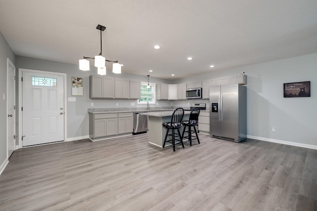 4001 Moreland Gap Rd, New Market, VA 22844 - kitchen with stainless steel appliances, baseboards, light wood-type flooring, a kitchen bar, and recessed lighting