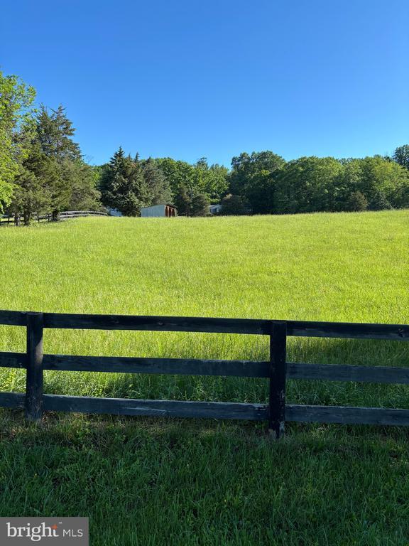  - view of yard featuring fence and a rural view