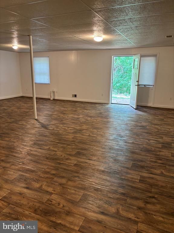  - below grade area with dark wood-style flooring and baseboards