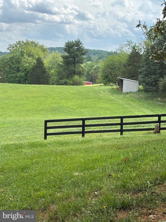  - view of yard featuring a view of countryside and an outbuilding