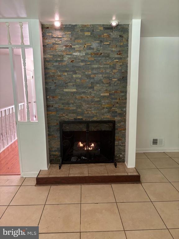  - detailed view of a warm lit fireplace and baseboards