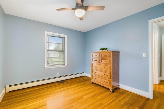 78 Stuart Ave, Stuarts Draft, VA 24477 - bedroom with a baseboard radiator, light wood-type flooring, baseboards, and a ceiling fan