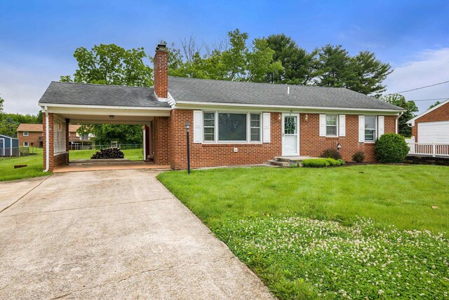 78 Stuart Ave, Stuarts Draft, VA 24477 - view of front facade with concrete driveway, brick siding, a front lawn, a chimney, and a carport